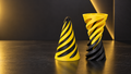 Twist Fidget with a bold yellow-and-black spiral design displayed on a dark surface