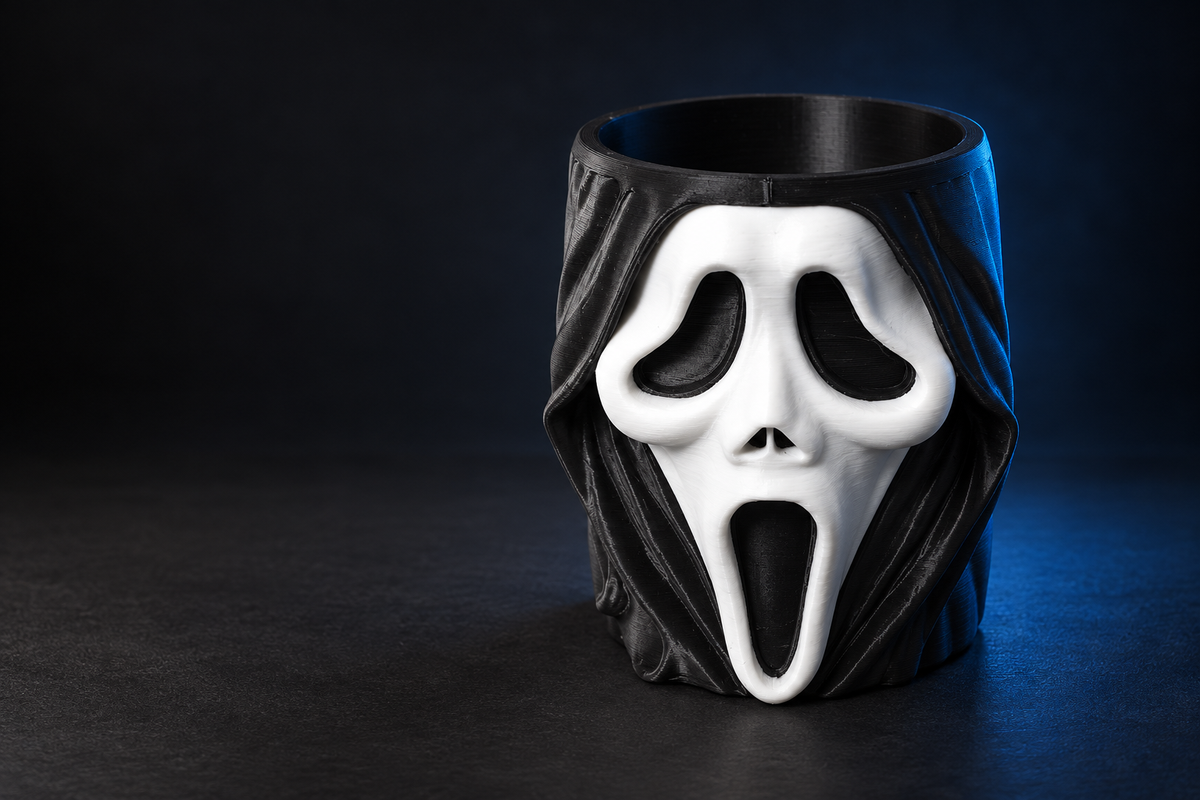 Black and white GhostFace-style pen holder on a dark background